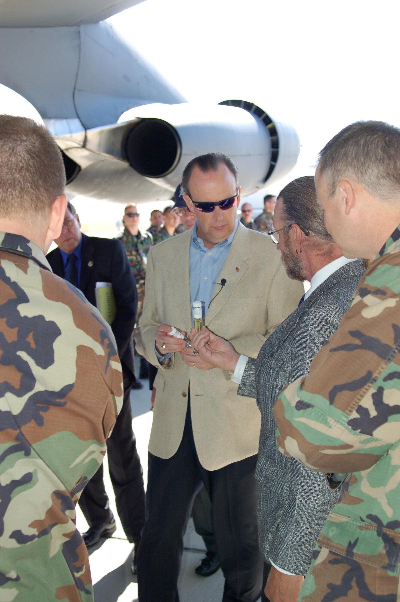 William C. Anderson, Assistant Secretary of the Air Force for Installations, Environment and Logistics, examines vials of a synthetic fuel that powered two of eight engines during a B-52 test flight here recently.  In addition to his interest in the synthetic fuel testing, Mr. Anderson visited the base to look at other energy-minded equipment in use here, including electric vehicles and an energy-efficient building. (Photo by Staff Sgt. Mark Woodbury)