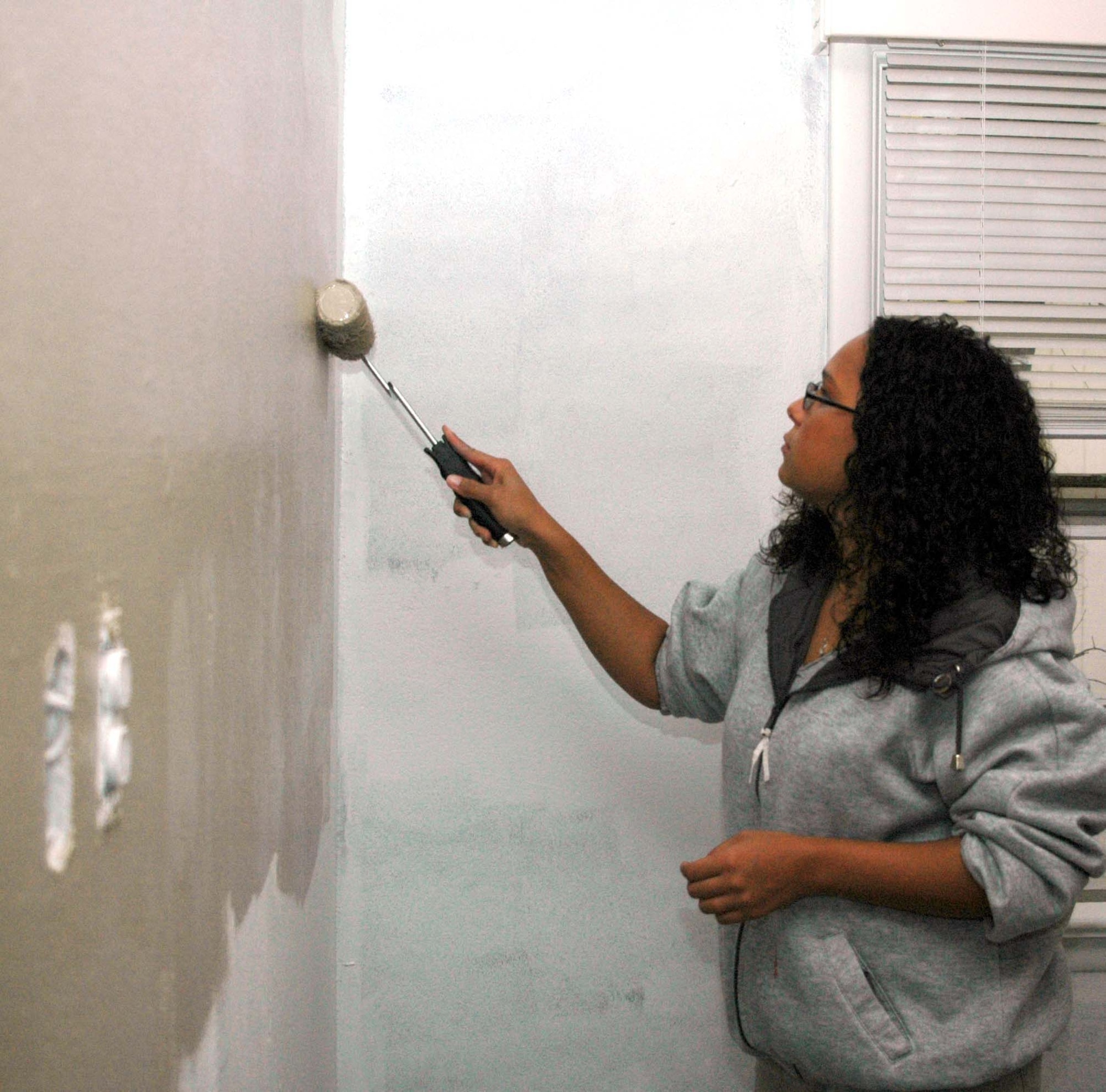 Senior Airman Rachel Jankowski stays busy giving the walls a fresh coat of paint at the Hosanna Home assisted living facility.