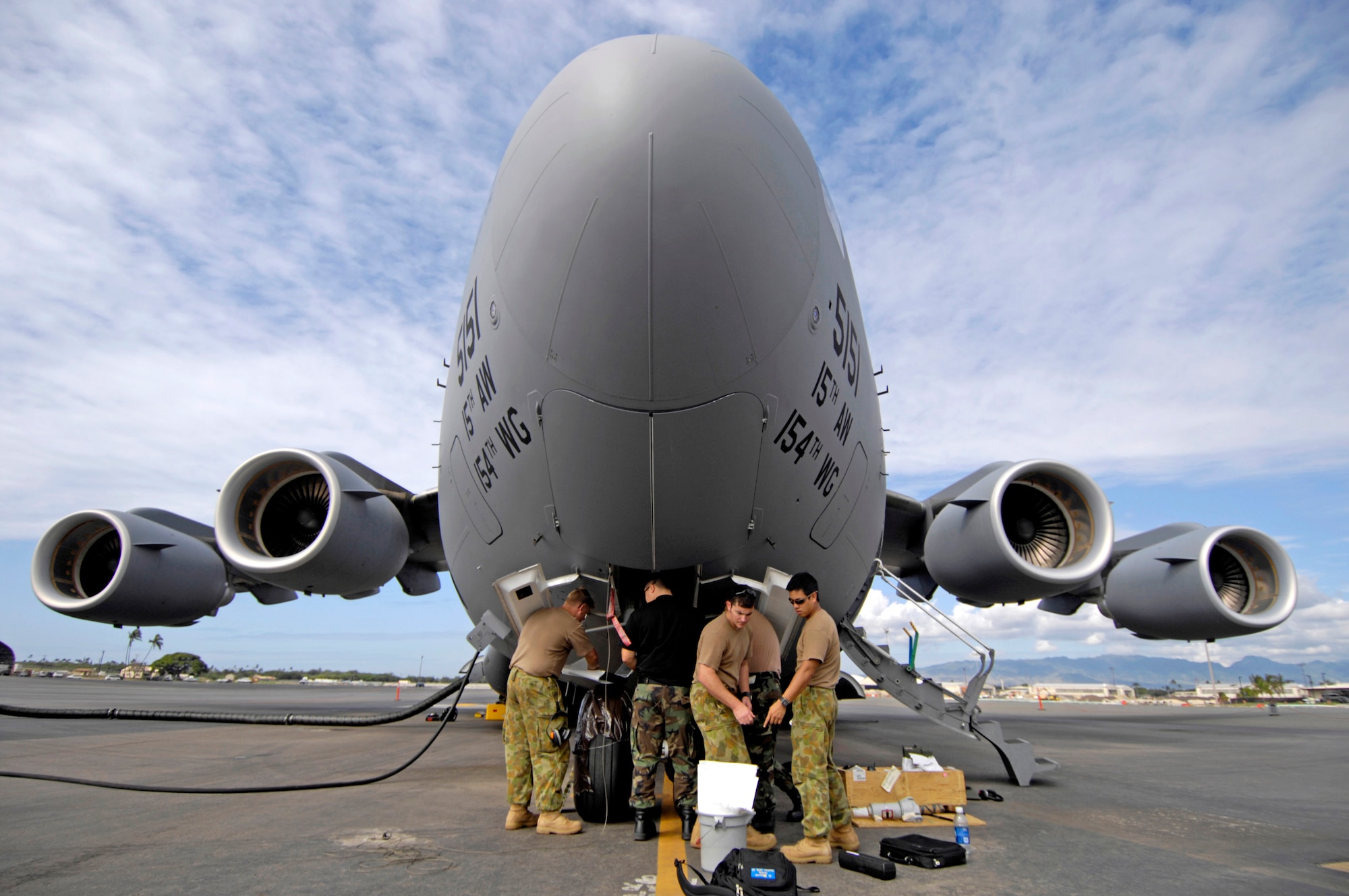 U.S. and Australian maintainers work on a C-17 Globemaster III nose steering actuator at Hickam Air Force Base, Hawaii, Oct. 19. Maintainers from Amberly Royal Australian Air Force Base are working alongside their U.S. Air Force counterparts to learn about the C-17. (U.S. Air Force photo/Tech. Sgt. Shane A. Cuomo) 