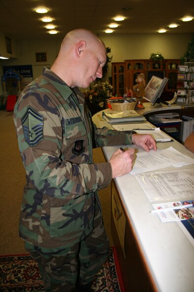 Senior Master Sgt. Todd Weidensaul, 39th Security Forces Squadron superintendent of plans and programs flight, fills out a form for use of the marquee at the community center Oct. 26. (U.S. Air Force photo by Staff Sgt. Oshawn Jefferson)