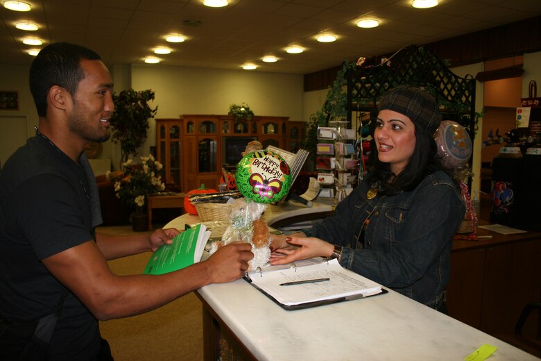 Seckin Atims, 39th Services Squadron community center recreation specialist, assists Joseph Lipscomb, a 21-year-old dependent, with purchashing a birthday gift at the "Just Because" Ballon and Gift Shop inside the community center Oct. 26. (U.S. Air Force photo by Staff Sgt. Oshawn Jefferson)