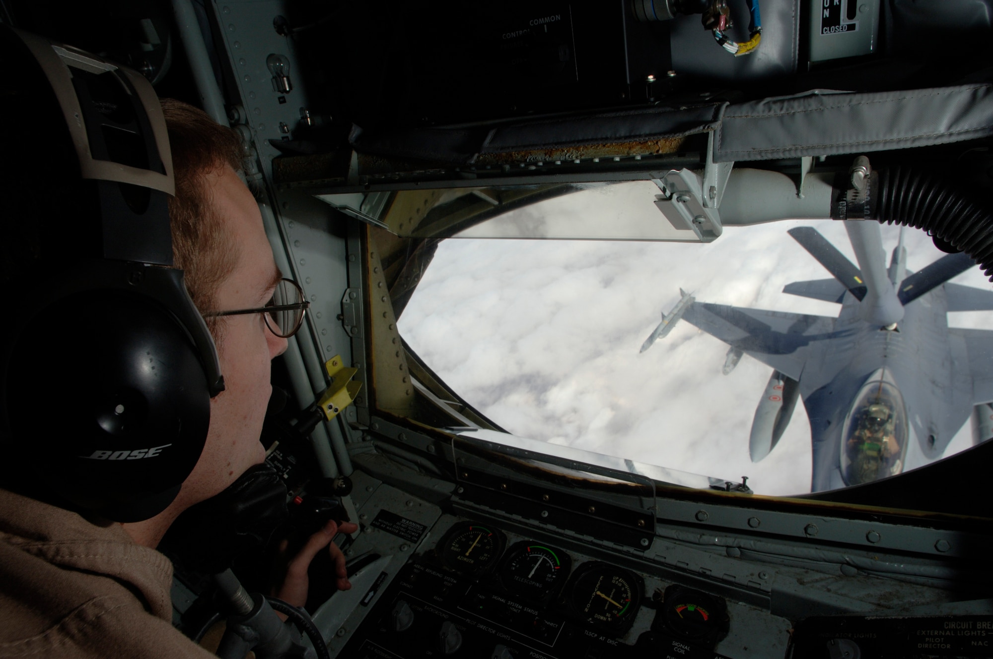 Senior Airman Jered Danielson refuels an F-16 Fighting Falcon from the KC-135R Stratotanker. As a boom operator, he helps extend the capability and range of all the aircraft he refuels. Airman Danielson is an in-flight refueling journeyman assigned to the 340th Expeditionary Air Refueling Squadron. He is deployed to Southwest Asia from the 911th Air Refueling Squadron at Grand Forks Air Force Base, N.D. The F-16 is deployed from Cannon AFB, N.M. (U.S. Air Force photo/Master Sgt. D. Scott Wagers) 