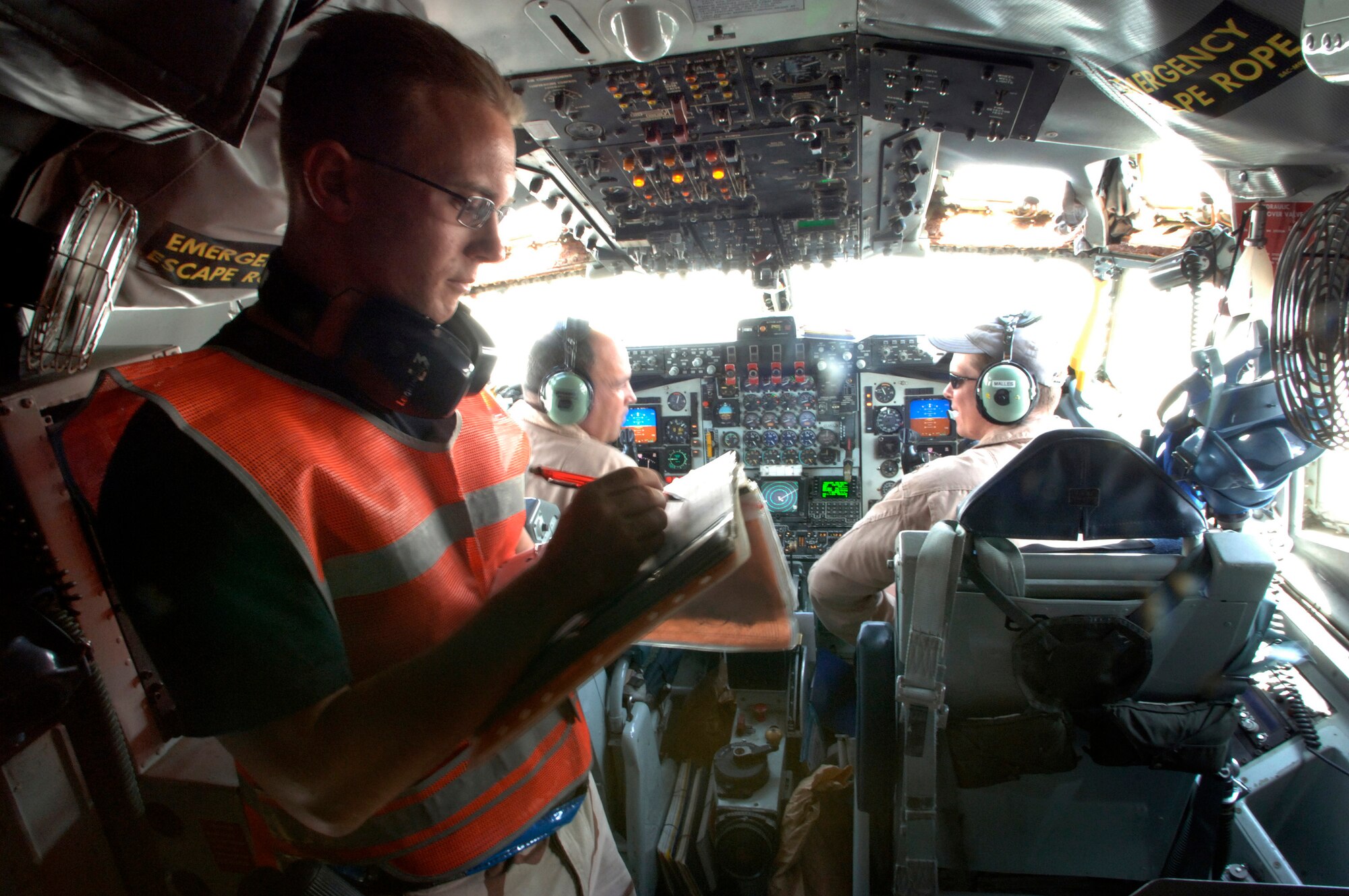 Airman 1st Class Jeremiah Johnson assists pilots Majs. Theodore Moore and Dan Malles in the preflight of a KC-135R Stratotanker prior to departure for an air refueling mission over Iraq. Airman Johnson is a communications and navigation specialist deployed to Southwest Asia from Grand Forks Air Force Base, N.D. (U.S. Air Force photo/Master Sgt Scottt Wagers)

