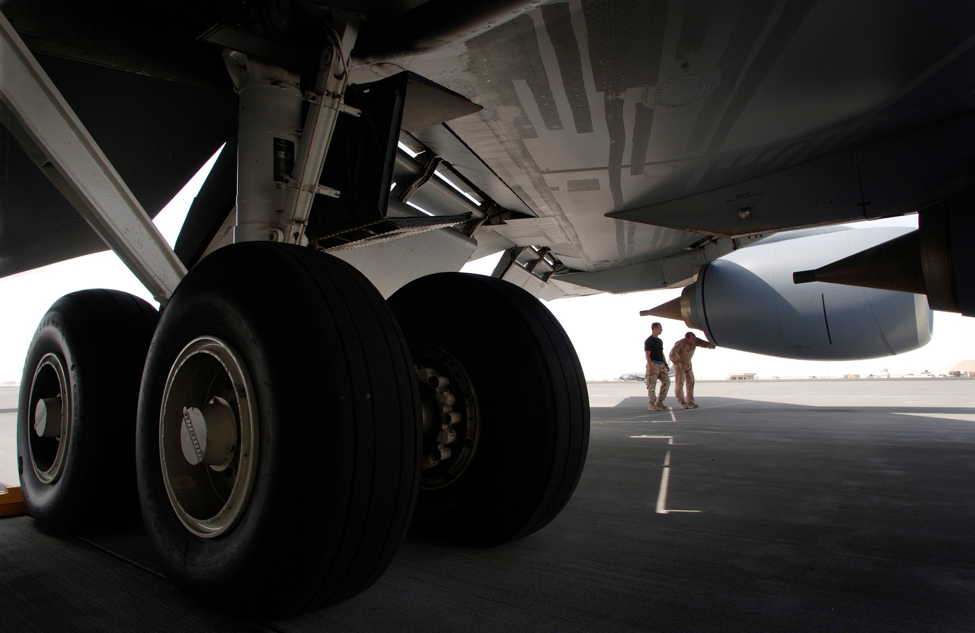 KC-135 Stratotanker pilot Maj. Theodore Moore conducts a preflight inspection of his jet with Airman 1st Class Jeremiah Johnson prior to departing on an air refueling mission over Iraq. Major Moore is deployed from McConnel Air Force Base, Kan., and Airman Johnson is a communications and navigation specialist deployed from Grand Forks AFB, N.D. Both are assigned to the 340th Expeditionary Air Refueling Squadron. (U.S. Air Force photo/Master Sgt Scottt Wagers)