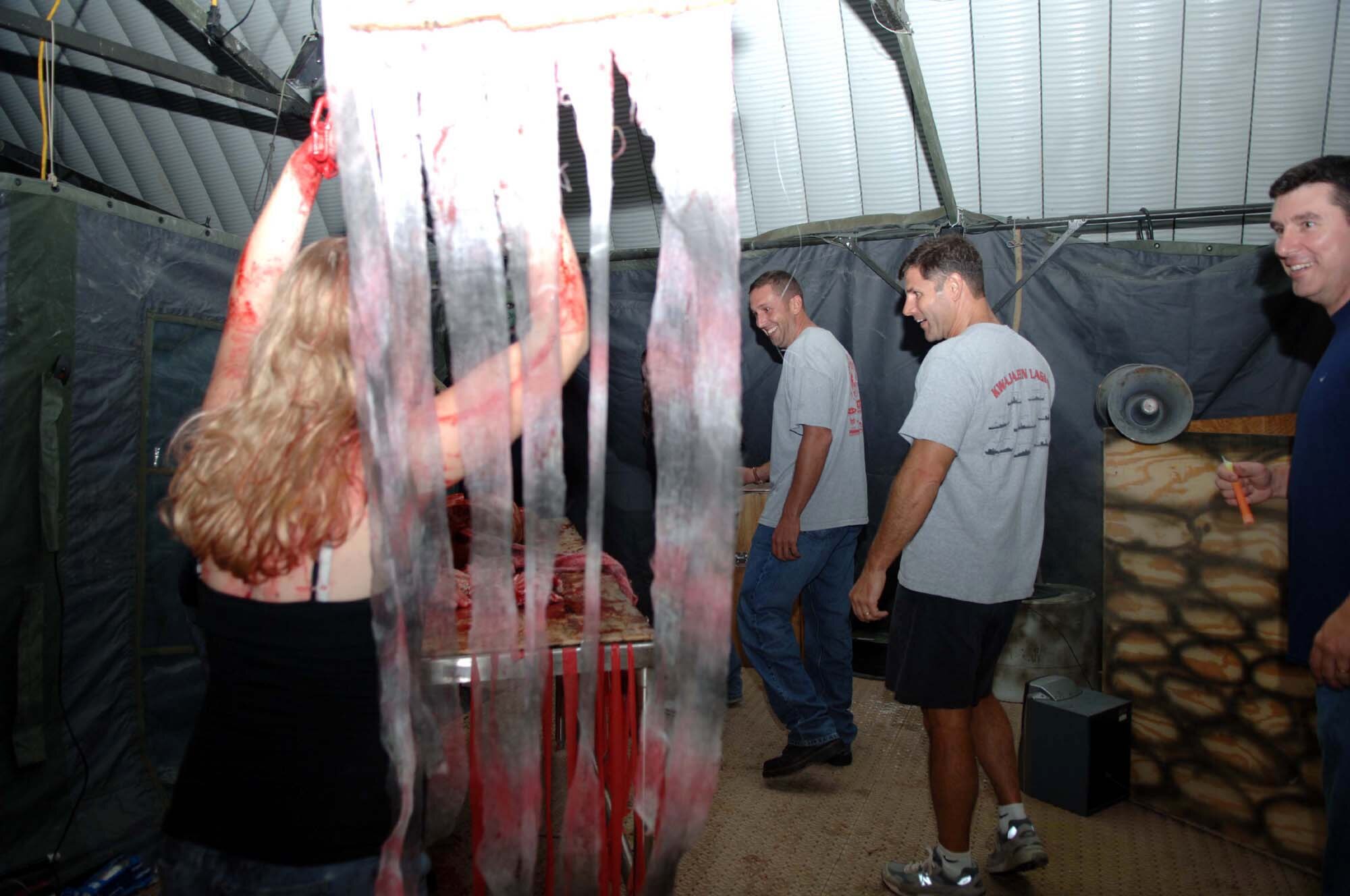 Customers go through the 823rd RED HORSE Squadron’s Haunted House here Oct. 21.  (U.S. Air Force Photograph by Senior Airman James Dickens)
