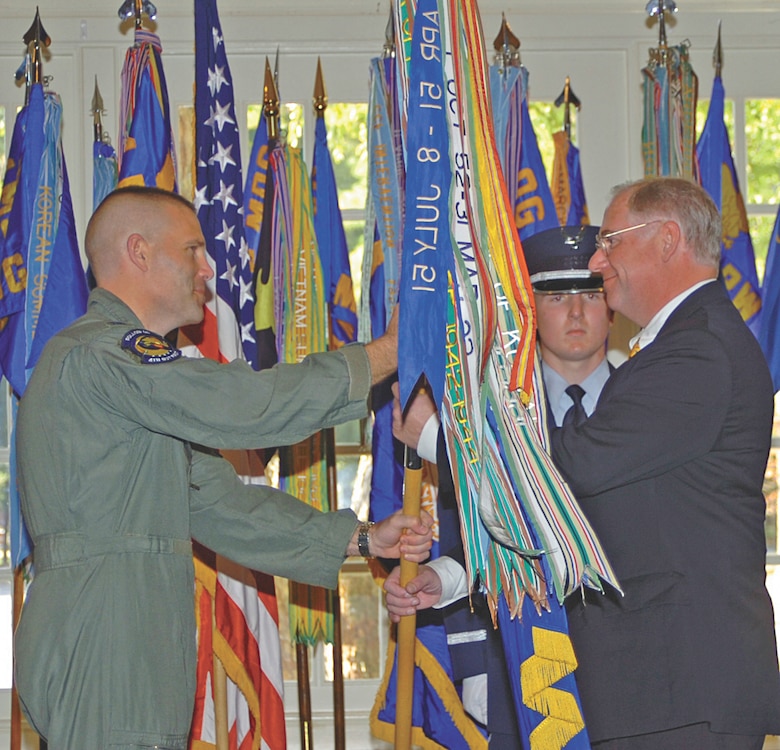 Col Steve Kwast, 4th Fighter Wing Commander presented the 4th FW flag to his honorary commander, Mr Henry Smith, Military Affairs Committee Chairman, at the Honorary Commanders Induction ceremony held Wednesday at the Officers? Club.  Thirty-four military commanders and their civilian counterparts from the 4th FW and 916th Air Refueling Wing were inducted in the Honorary Commanders program that is designed to foster solid bonds between Seymour Johnson and the community.  (U.S. Air Force photo by Airman 1st Class Jonathon Williams)