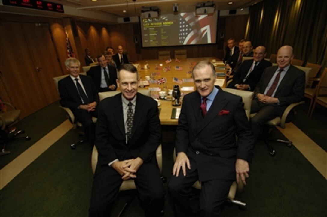 Chairman of the Joint Chiefs of Staff Marine Gen. Peter Pace and his British counterpart,  Air Chief Marshal Sir Jock Stirrup, pose for a photo prior to a meeting at the British Ministry of Defense in London, Oct. 26, 2006. 