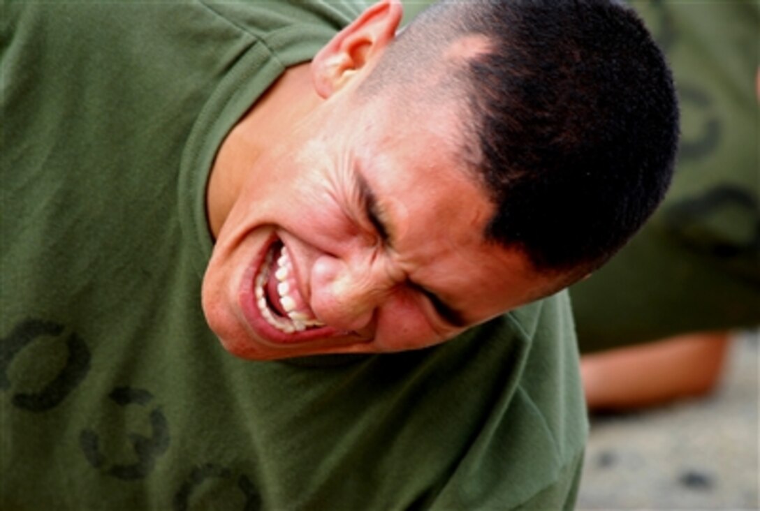 U.S. Marine Corps Pvt. Santos Pelayo Jr., struggles as he conducts strenuous trunk raises – an exercise where an individual suspends his body using only his arms and feet - at Marine Corps Recruit Depot San Diego, Oct. 26, 2006.
