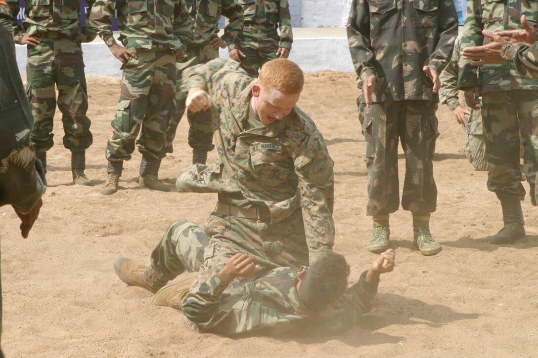 BELGAUM, India (Oct. 27, 2006) - Lance Cpl. Deryck Lewis, an infantry man with 1st Platoon, Echo Co., Battalion Landing Team 2/4, finishes an Indian army martial arts move, called the stomach throw, on a soldier with India army's Alpha Co., 21st Battalion, The Punjab Regiment here. Marines of Echo Co. are participating in Exercise Shatrujeet 06, which began 25 October 2006 where they are currently training with the Indian Army in basic infantry tactics. The 15th Marine Expeditionary Unit (Special Operations Capable), part of the Boxer Expeditionary Strike Group aboard the USS Boxer (LHD 4), USS Dubuque (LPD 8) and the USS Comstock (LSD 45), is currently deployed in the Western Pacific region.