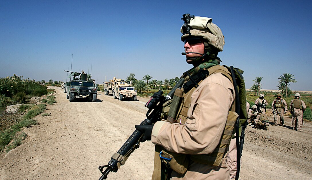 Cpl. Jason D. Green, a 24-year-old vehicle commander with Security Company, Combat Logistics Battalion 5, 1st Marine Logistics Group (Forward), surveys the scene at an explosion site.  What?s most exciting is heading out into the unknown, said Green from Meridian, Id.  Green explained that in the unfamiliar, urban territory of Fallujah, fighting a faceless enemy always keeps these security Marines focused.  ?You have to count on (the other Marines) so you can take care of your mission,? said Green. ?(We have) a very strong bond because you have to rely on the brother next to you.?