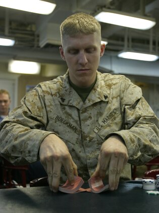Corporal Jeremiah T. Boeckman, an Anchorage, Alaska native, and a radio technician with the 26th Marine Expeditionary Unit, BLT 2/2,  Headquarters and Support Company, shuffles a deck of cards during a Morale, Welfare, and Recreation Texas Hold 'em poker tournament, Oct. 28, 2006, aboard USS Bataan.  The 26th MEU is conducting exercises with the Bataan Strike Group to ready for a scheduled 2007 deployment in the Global War on Terror.  (USMC photo by Lance Cpl. Patrick Johnson-Campbell)