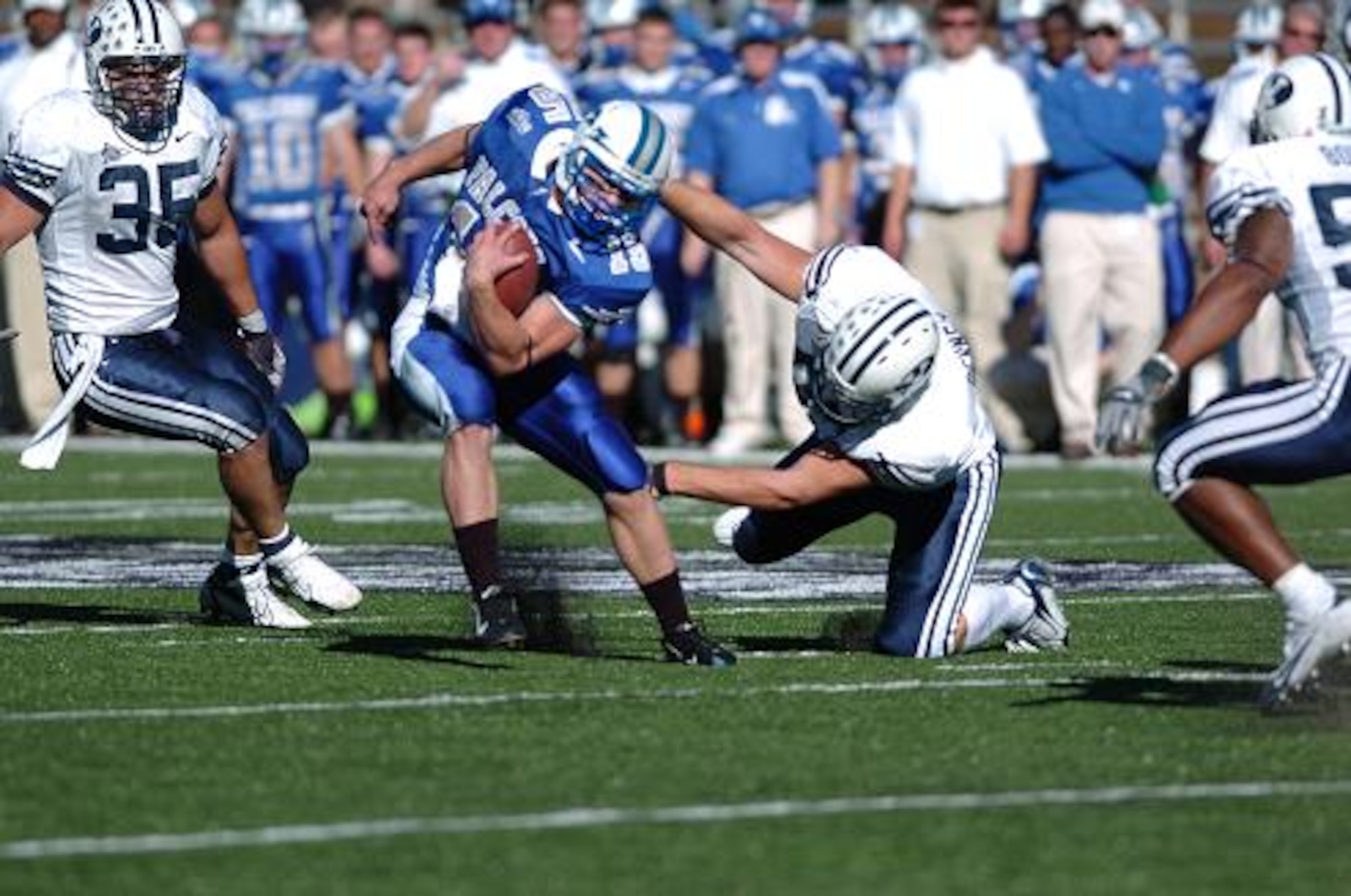 Air Force second-string quarterback Jim Ollis shakes off BYU defensive lineman Brett Denney on an eight-yard pick up and a first down late in the fourth quarter Saturday.  Ollis led the Falcons on a 16-play touchdown drive, but the clock ran out on Air Force.  BYU won, 33-14. (U.S. Air Force Photo/1st Lt. John Ross)