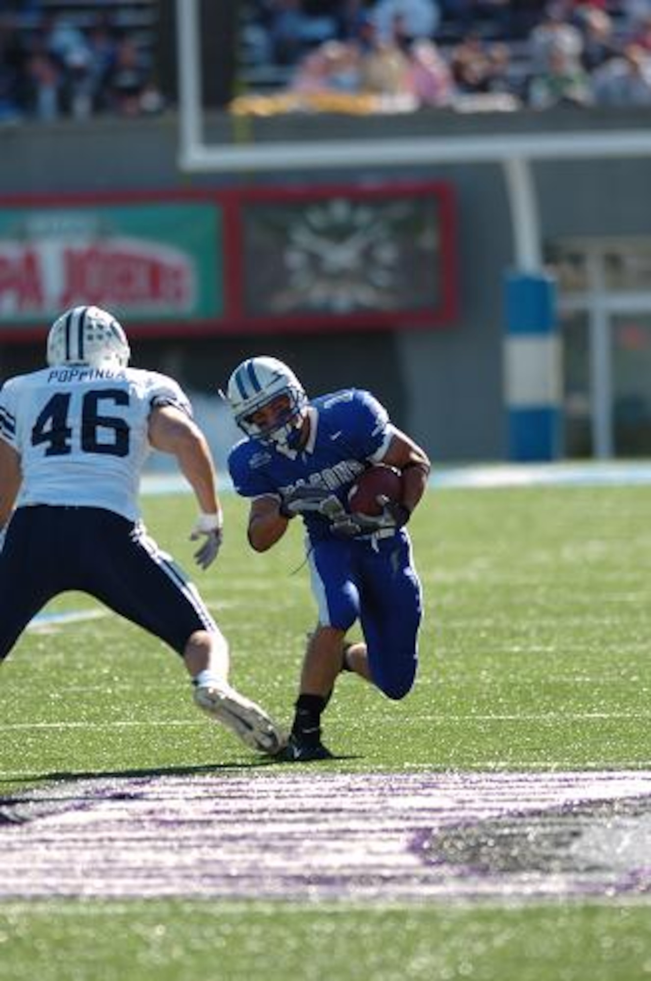 Air Force halfback Chad Hall gives BYU linebacker Kelly Poppinga a head fake on a short run into BYU territory Saturday. Though the Falcons out-rushed BYU 190 yards to 153, the Cougars' 253 pass yards more than made up for the deficit. BYU won, 33-14. (U.S. Air Force Photo/1st Lt. John Ross)