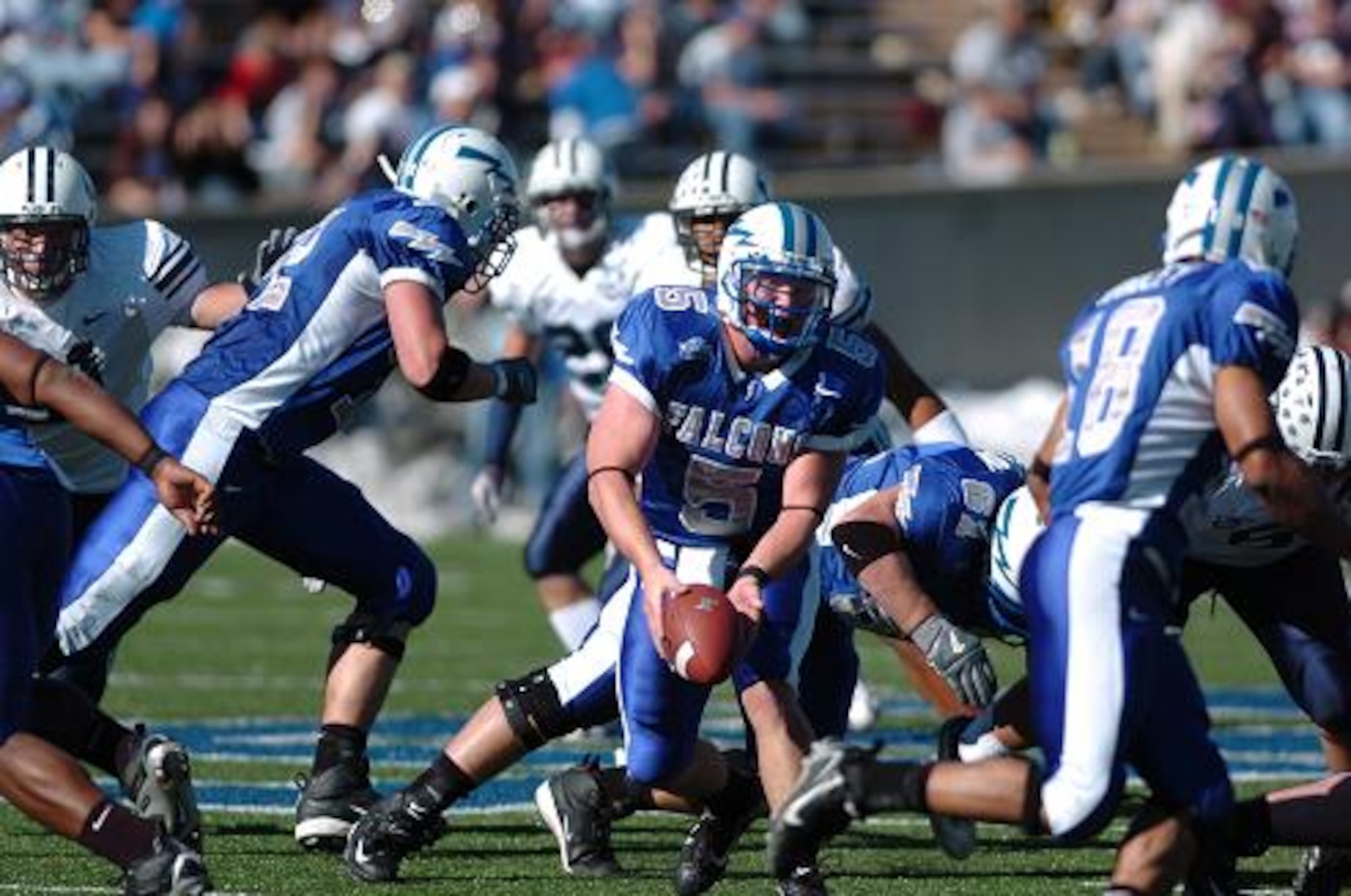 Air Force quarterback Shaun Carney pitches the ball to halfback Justin Handley for a short pick-up. Though the Falcons out-rushed BYU 190 yards to 153, the Cougars' 253 pass yards more than made up for the deficit. BYU won, 33-14.  (U.S. Air Force Photo/1st Lt. John Ross)