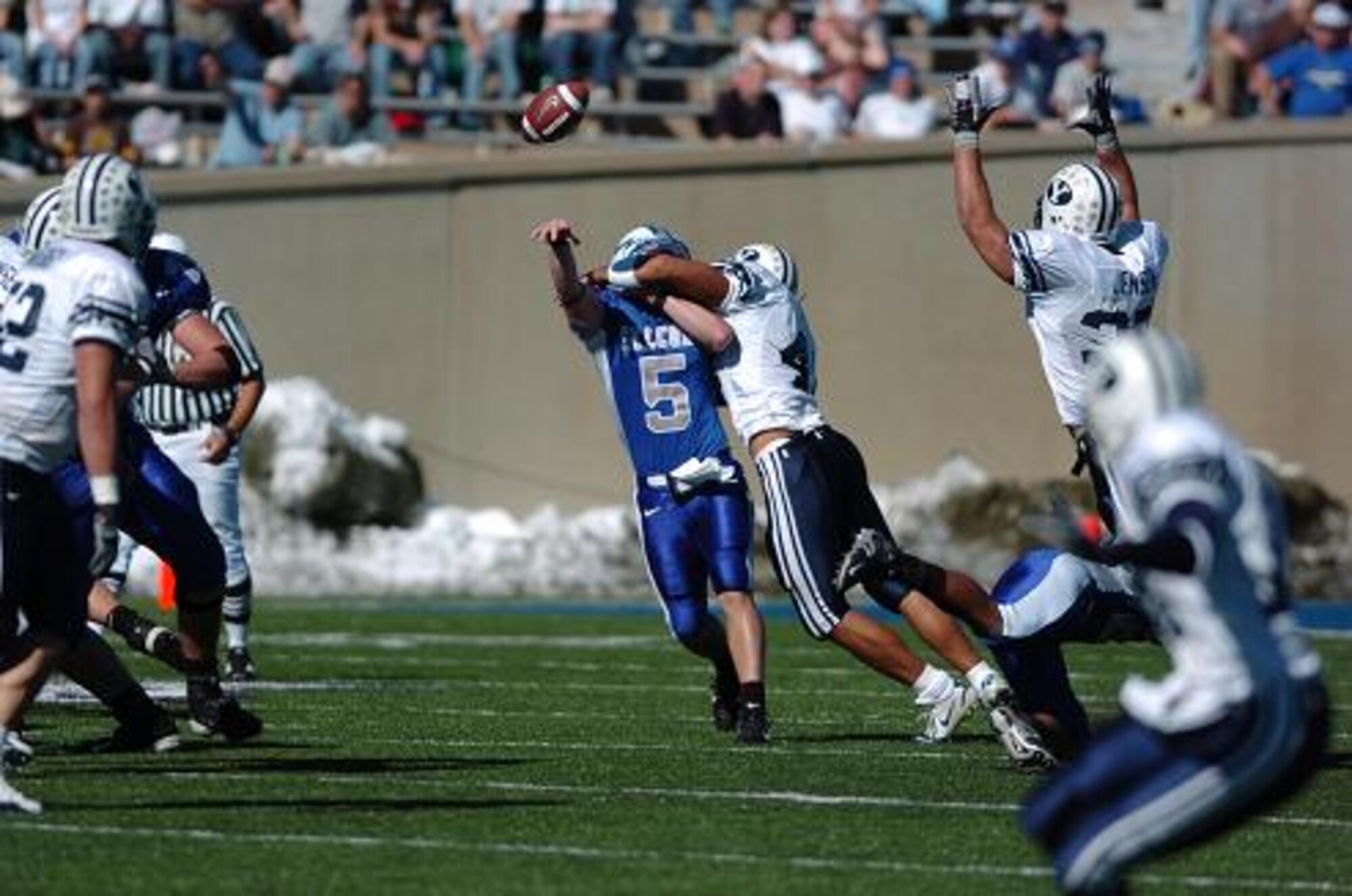 BYU linebacker Bryan Kehl hits Air Force quarterback Shaun Carney as he throws, resulting in an interception by fellow linebacker Aaron Wagner. The Falcons' 229 total yards was not enough to match BYU's 411. BYU won, 33-14.  (U.S. Air Force Photo/1st Lt. John Ross)