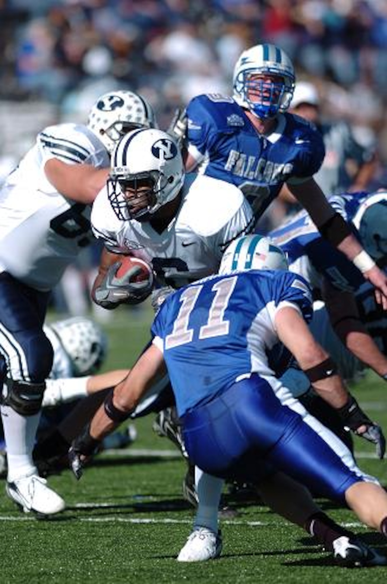 BYU running back Curtis Brown weaves through defenders for five yards before meeting Falcon free safety Bobby Giannini in the first quarter. BYU's 411 total offensive yards, compared to Air Force's 229, proved too much for the Falcons. BYU won, 33-14.  (U.S. Air Force Photo/1st Lt. John Ross)