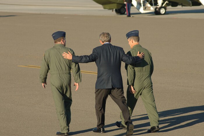 President George W. Bush walks with Col. Glen Jorger, 437th Airlift Wing commander, and Col. Timothy Wrighton, 315th Airlift Wing commander, to Marine One after giving a motivational speech to the Airmen at Charleston Air Force Base, S.C., Oct. 28, 2006.  President Bush came to South Carolina to thank the Airmen at Charleston AFB for their contributions to the Global War on Terrorism. (U.S. Air Force photo/Staff Sgt. April Quintanilla) (RELEASED)