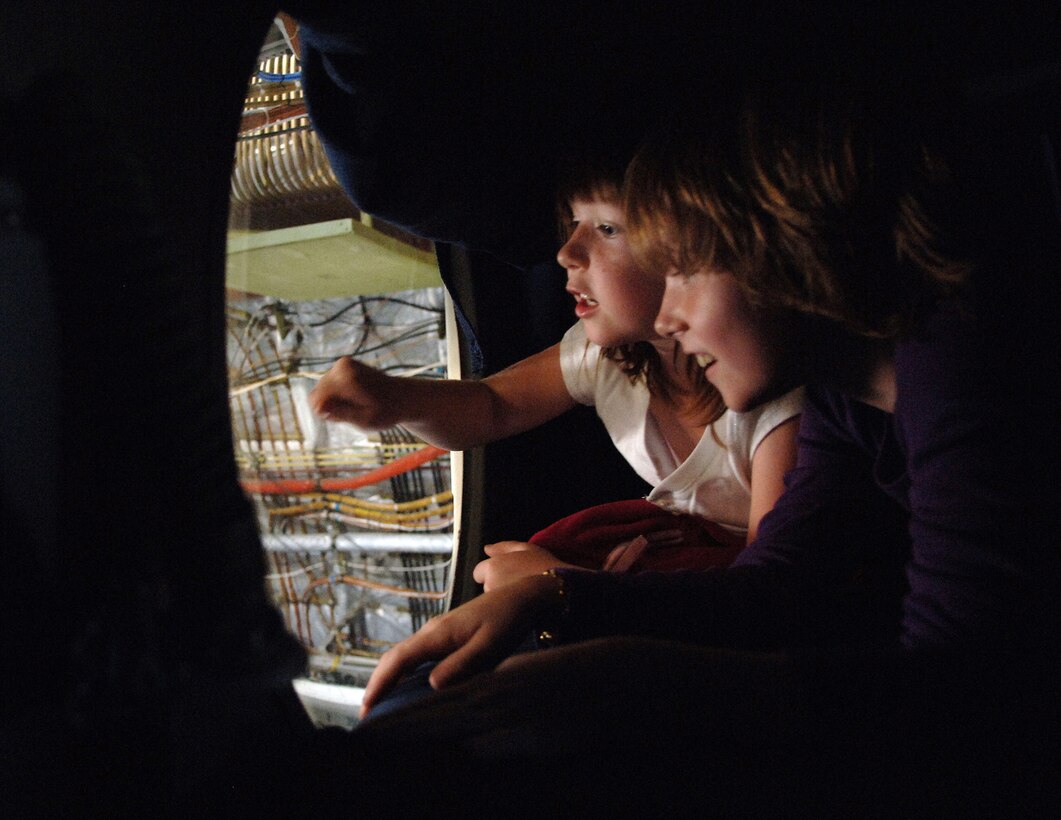 Mia Noonan, left, 6, Jarret Noonan, 8, watch and wave to people below inside a C-17 Globemaster III shortly before President George W. Bush delivered a speech at Charleston Air Force Base, S.C., Oct. 28. The C-17 static display was open to all servicemembers and families to view before the speech. More than four thousand servicemembers and families attended the presidential rally were he spoke on the war on terrorism. Mia and Jarret are daughters of Capt. Vance Noonan, a pilot with the 15th Airlift Squadron. (U.S. Air Force photo/Tech. Sgt. Larry A. Simmons)