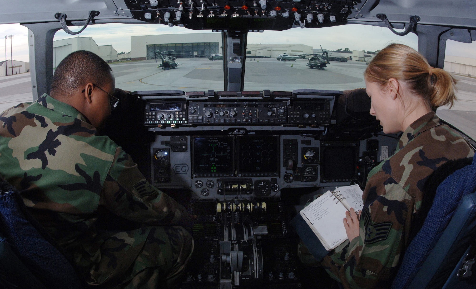 Staff Sgts. Chris Brown, left, and Sarah Hall perform a preflight inspection on a C-17 at Charleston Air Force Base, S.C. on Oct. 27. This inspection helps ensure the C-17 is fully operational when the crew arrives. Sergeants Brown and Hall are aircraft maintenance craftsman with the 437th Aircraft Maintenance Squadron.(U.S. Air Force photo/Tech. Sgt. Larry A. Simmons)