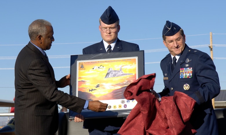 Guest speaker, retired Gen. Lloyd "Fig" Newton and Brig. Gen. David Goldfein unveil the Silver Stealth lithograph at the 25th Anniversary celebration at Holloman Air Force Base, N.M., Oct. 27. General Newton was instrumental in the success and integration of the early history of the F-117 Nighthawk. General Goldfein is the 49th Fighter Wing commander. (U.S. Air Force photo/Senior Airman Brian Ferguson)