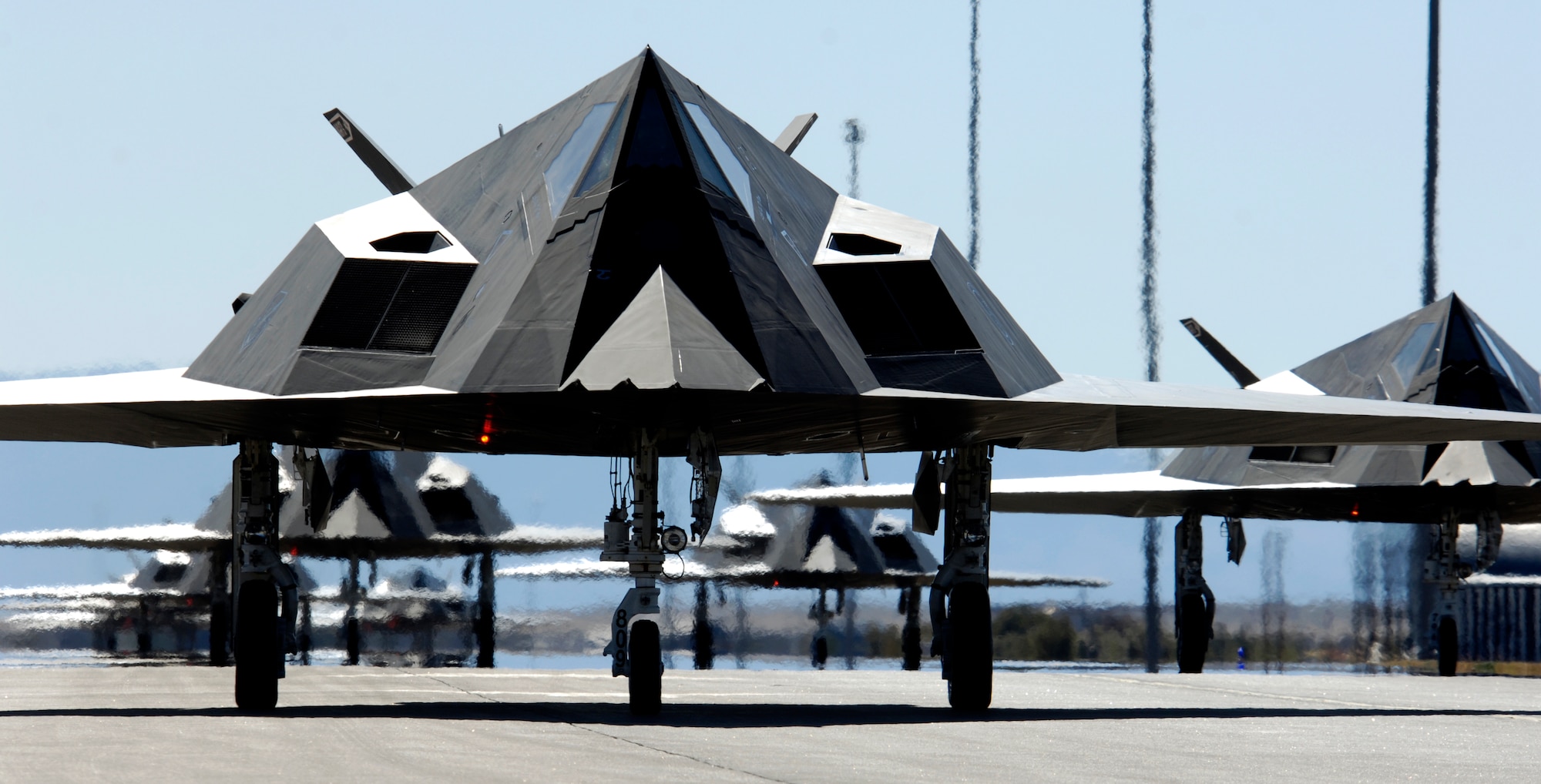 Twenty-five F-117 Nighthawks line up before takeoff from Holloman Air Force Base, N.M. The planes were part of a formation celebrating the Nighthawk's 25th anniversary and 250,000 flying hour. The 25 aircraft were separated into five groups and flew over the base to end the celebration ceremony. (U.S. Air Force photo/Senior Airman Brian Ferguson)
