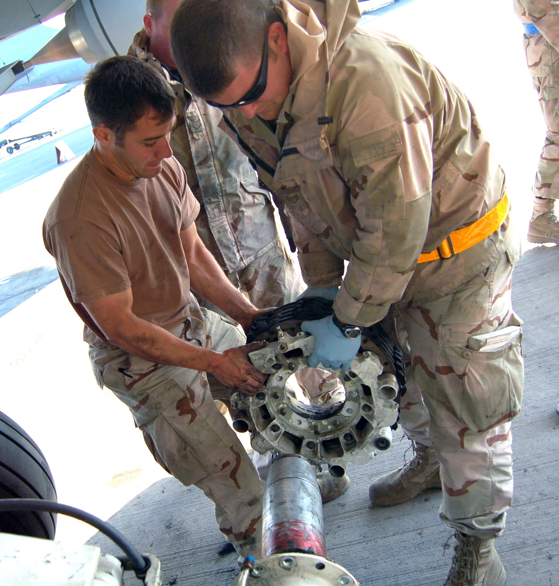 Staff Sgt. Carl Graves-Klaric (left) and Airman First Class Neal Sicard change the brake on the No. 1 tire of a KC-135 Stratotanker.  Sergeant Graves-Klaric is deployed from the 92nd Aircraft Maintenance Squadron, Fairchild Air Force Base, Wash., and Airman Sicard is deployed from the 319th AMXS, Grand Forks AFB, N.D. (U.S. Air Force photo/Master Sgt. Mitch Gettle)