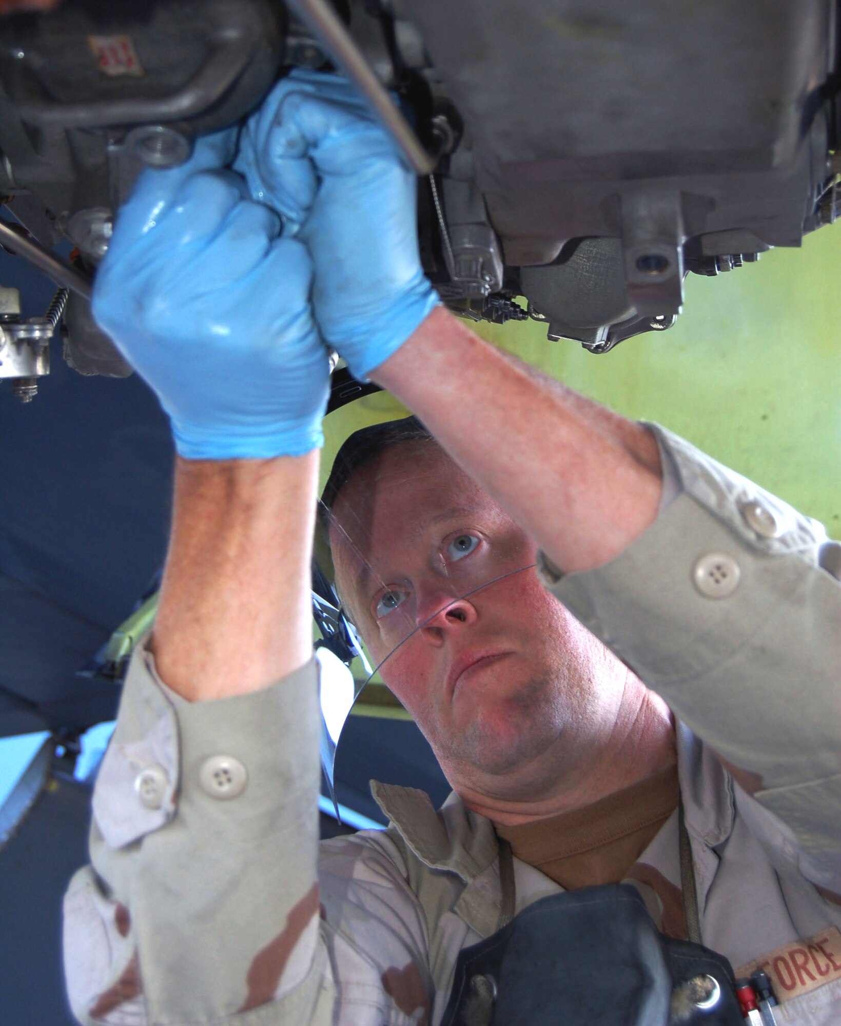 Tech. Sgt. Fred Asbury tightens the fuel filter bolts on a KC-135 Stratotanker engine. Scheduled maintenance on the aircraft is determined by monitoring the hourly use-rate of aircraft components.  Sergeant Asbury is a KC-135 jet engine mechanic deployed from the 92nd Aircraft Maintenance Squadron, Fairchild Air Force Base, Wash. (U.S. Air Force photo/Master Sgt. Mitch Gettle)