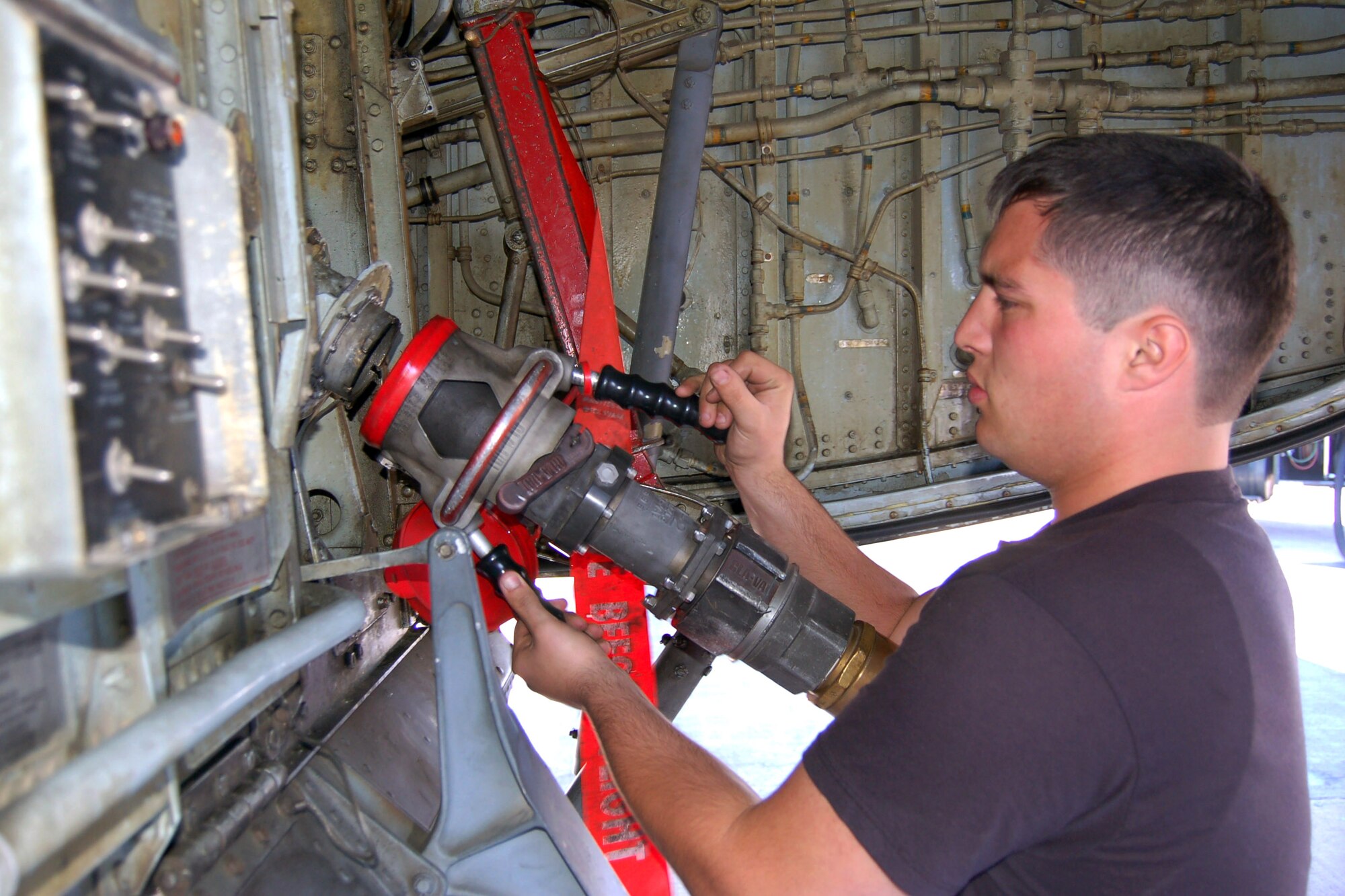Senior Airman Danny Pierce attaches the fuel line to the intake valve of a KC-135 Stratotanker. Crew chiefs are responsible for launch, recovery, configuration and general servicing of the aircraft. Airman Pierce is a KC-135 crew chief deployed from the 92nd Aircraft Maintenance Squadron, Fairchild Air Force Base, Wash. (U.S. Air Force photo/Master Sgt. Mitch Gettle)