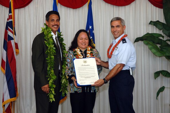 Hawaii Lt. Gov. James Aiona Jr., Dr. Chiyome L. Fukino and Col. John Torres display the proclamation Oct. 26 announcing "Enforcing Underage Drinking Laws Program" Day at Hickam Air Force Base, Hawaii.  Hickam was selected to receive a grant from the Department of Justice which will allow the base and the state to share $950 thousand over the next three years with the goal of reducing drinking by underage Airmen.  Dr. Fukino is the director of the Hawaii State Department of Health.  Colonel Torres is the 15th Airlift Wing commander.  (U.S. Air Force photo) 