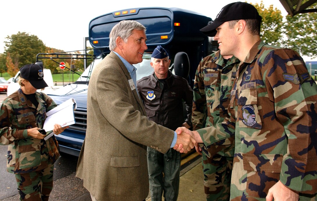 ROYAL AIR FORCE MILDENHALL, England - Mr. Robert E. “Bob” Largent, chairman of the board, Air Force Sergeant’s Association, shakes hands with Airman 1st Class Zebulon Willoughby, far right, 727th Air Mobility Squadron, outside the passenger terminal during his visit here, October 26, 2006. (US Air Force photo by Tech. Sgt. Jeanette Copeland)