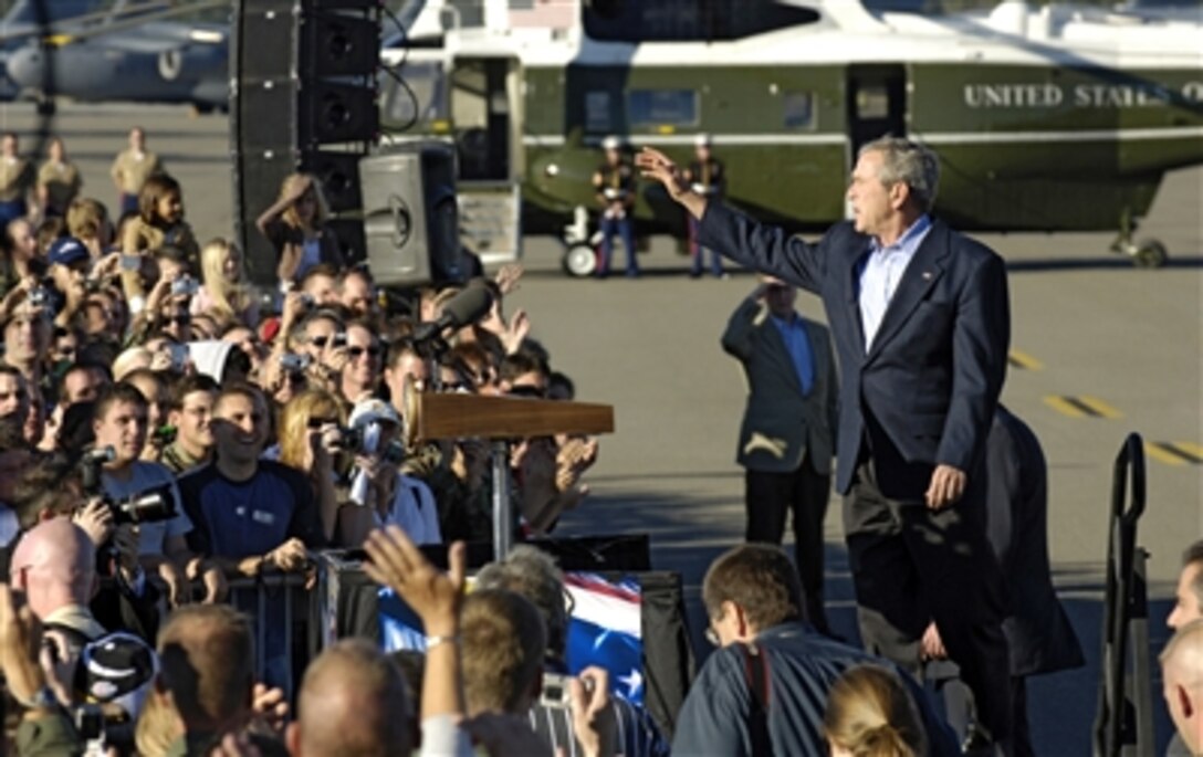 President George W. Bush waves to the crowd during his motivational speech to U.S. servicemembers at Charleston Air Force Base, S.C., Oct. 28, 2006. The president thanked the troops for their contributions to the war on terror. Bush specifically commended the 315th and 437th Air Wings.