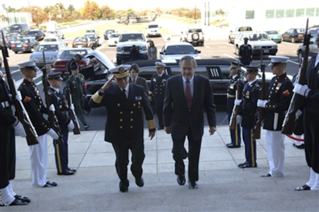 Defense Secretary Donald H. Rumsfeld, right, escorts Secretary of the Navy of Mexico Adm. Marco Antonio Peyrot Gonzalez through a cordon of honor guards and into the Pentagon, Oct. 30, 2006. The two defense leaders met to discuss issues of mutual interest. 
