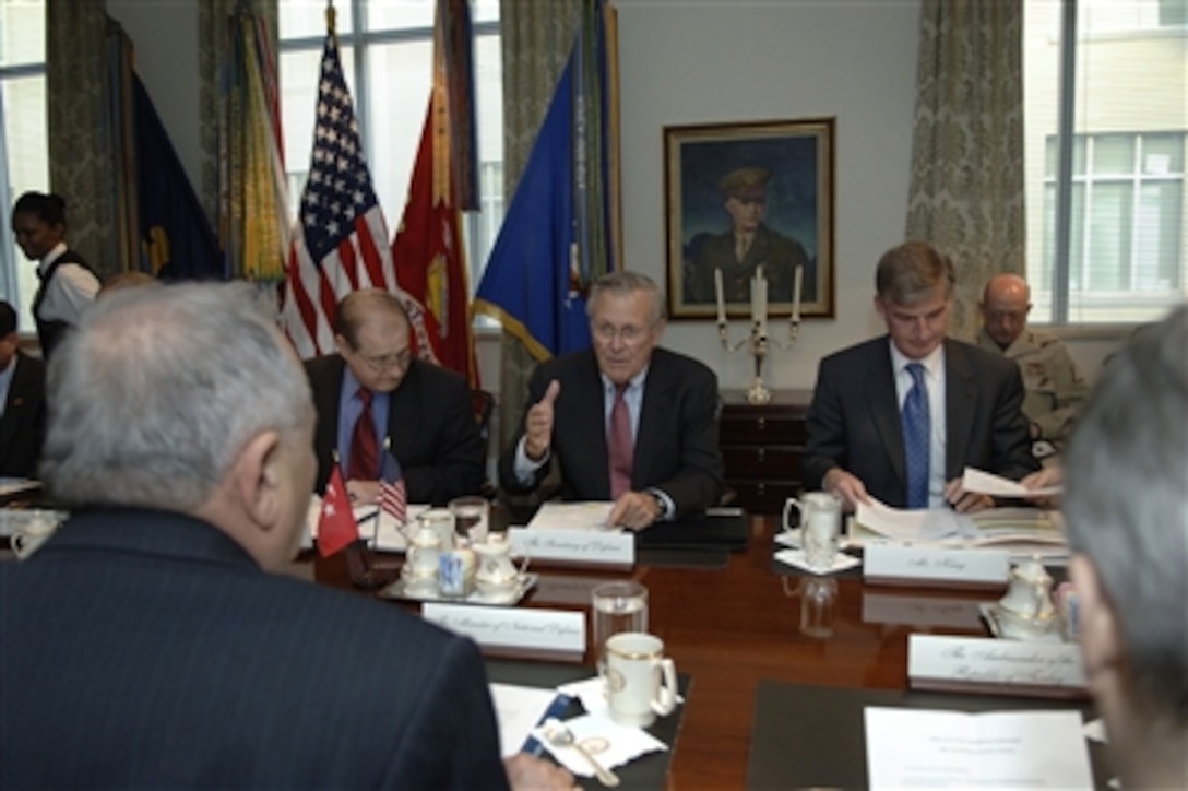 Defense Secretary Donald H. Rumsfeld, center, talks with Turkish Minister of Defense Vecdi Gonul during a working lunch in the Pentagon, Oct. 30, 2006. The two defense leaders met to discuss issues of mutual interest