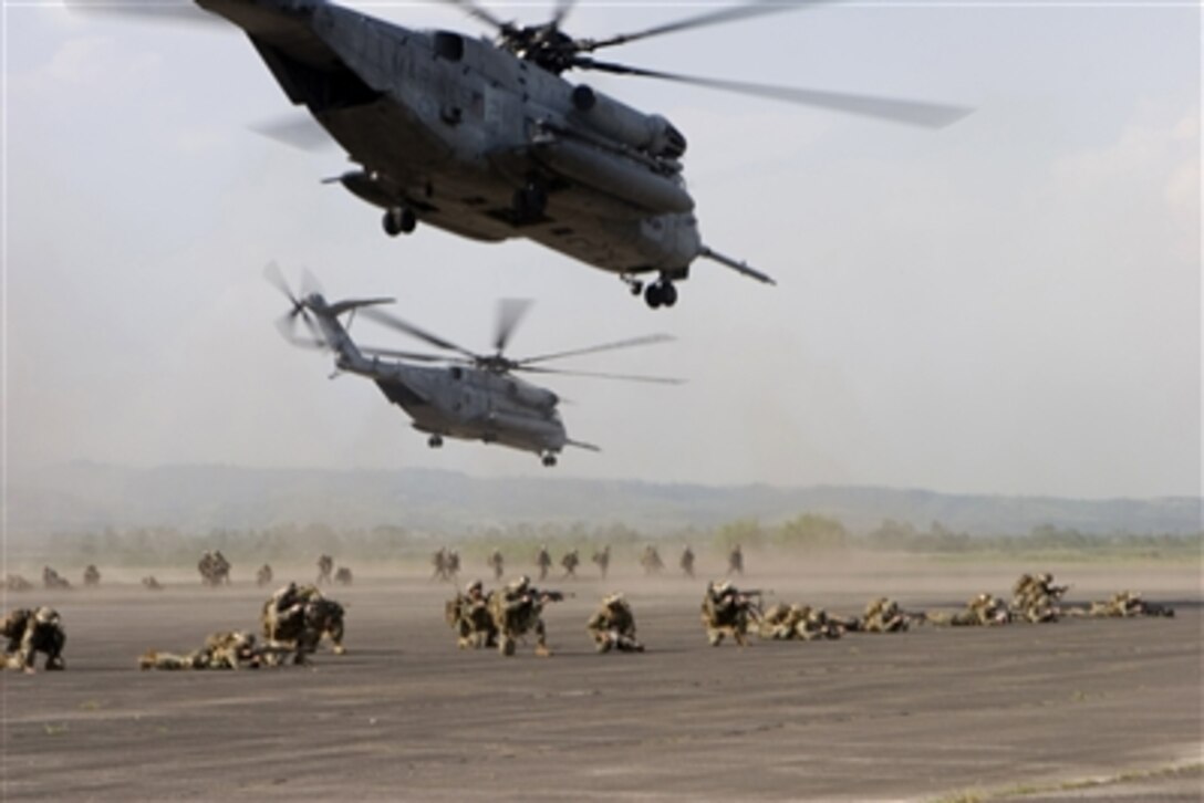 U.S. Marines and sailors provide security after dismounting from CH-53E Super Stallion helicopters at Cesar Basa Air Base in Pampanga, Philippines, on Oct. 15, 2006.  The Marines and sailors are conducting a long-range helicopter-borne raid with assistance from members of the Philippine air force as part of bilateral training exercises Talon Vision and Amphibious Landing Exercise FY '07.  Members of Battalion Landing Team 1st Battalion, 5th Marine Regiment of the 31st Marine Expeditionary Unit are conducting the exercises which are designed to enhance interoperability and professional relations between the U.S. and Philippine armed forces.  