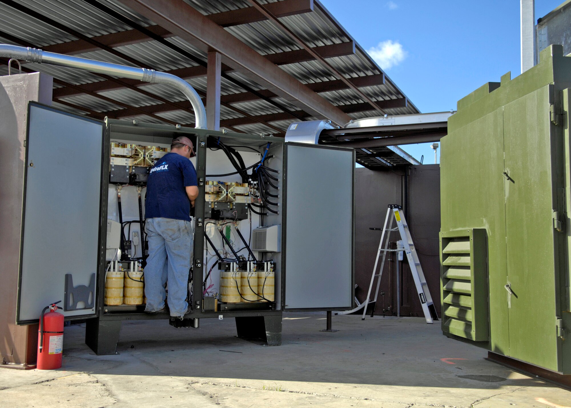 Matthew Morse lands power leads for the water purification system on the power supply for the HydraFLX System at Hickam Air Force Base, Hawaii Oct. 27, 2006. Morse is program engineer for HydraFLX Systems LLC. The HydraFLX System is being tested by the Air Force as an alternate energy source. It will generate ultra-pure H2 (hydrogen) from water in a flexible pressure management process for fueling buses, tow-tractors, vans, sedans and ground support equipment. The system can also be deployed anywhere and operate in hostile theaters without infrastructure or pipelines. (U.S. Air Force photo/Tech. Sgt. Shane A. Cuomo)
