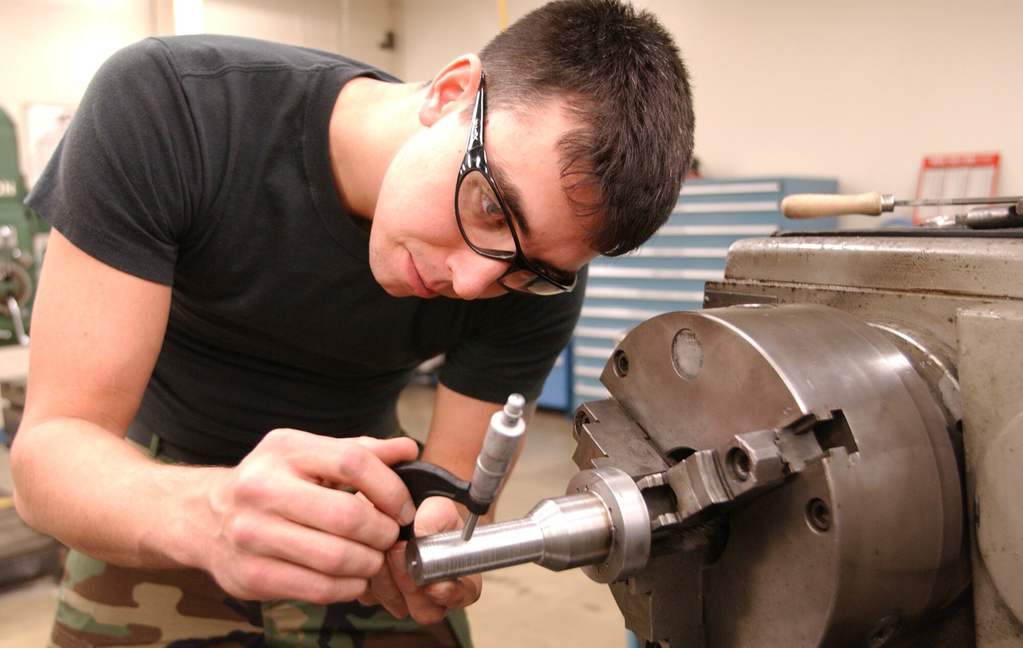 GRAND FORKS AFB, N.D. – Senior Airman Jake Schargus, a metals technology technician with the 319th Maintenance Squadron, uses a caliper to test the width of a part for an order. Metals technicians not only make parts for the aging KC-135 as well as specialized tools for various customers. (photo/Airman 1st Class Ashley Coomes)