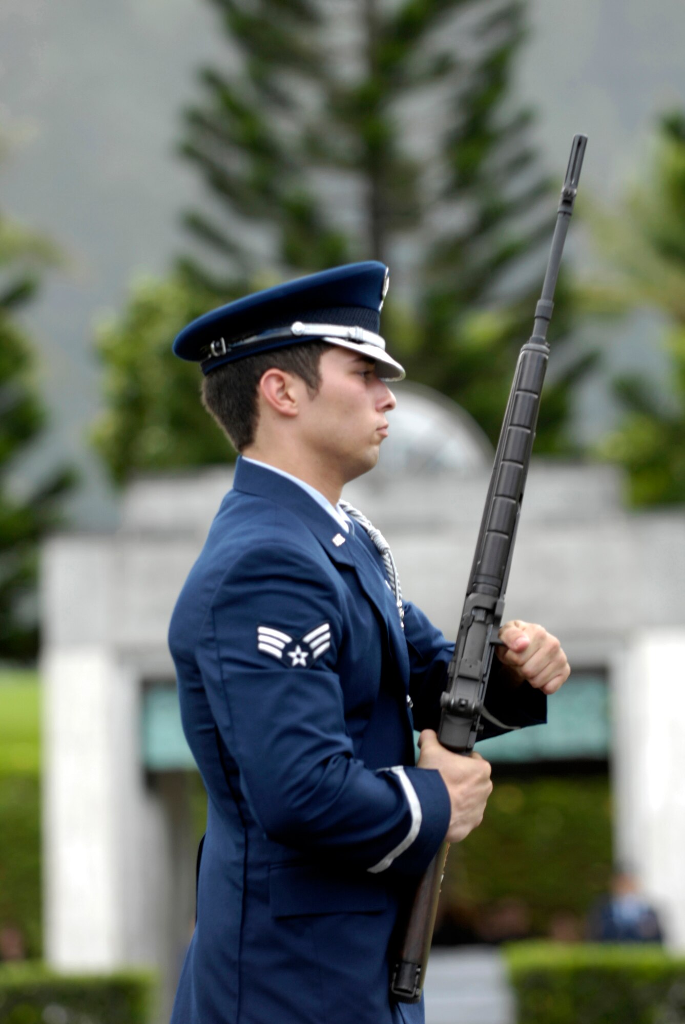 Senior Airman Patrick Campbell charges his weapon before firing a volley Oct. 26 during a veteran's funeral at Hawaii Veterans Cemetery. Airman Campbell is a member of the 15th Airlift Wing Honor Guard at Hickam Air Force Base, Hawaii. The base honor guard is rendering military honors to the veteran and his family. (U.S. Air Force photo/ Tech. Sgt. Shane A. Cuomo)