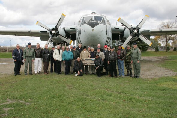 NIAGARA FALLS AIR RESERVE STATION, NY- 914th AW Commander Col. James Roberts (center) speaks to a crowd during  the C-119 dedication ceremony held here recently while 440th AW Commander Col. Merle Hart (right) and Senior Master Sergeant Flores of the 440th AW (left) look on.  The C-119 was acquired from the 440th AW stationed at General Mitchell Air Reserve Station, Wisconsin.  Due to the Base Realignment & Closure Commissions decision to close Gen. Mitchell ARS all assets are being distributed and utilized throughout the Air Force.  The C-119 was dismantled at Gen Mitchell ARS, transported by tractor trailer to Niagara Falls ARS where it was reassembled and dedicated as a reminder to the 914th AW historical linage.  Photo by: Senior Master Sergeant (Ret.) Mike Harvey (Released)