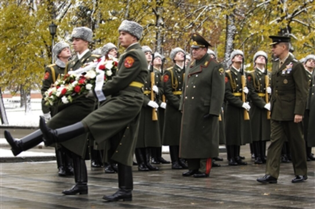 Chairman of the Joint Chiefs of Staff Marine Gen. Peter Pace, far right, marches forward to lay a wreath as part of a ceremony at the tomb of the unknown soldier in Moscow, Oct. 30, 2006.  