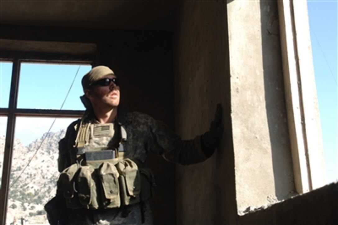 A U.S. Army sniper from the Jalalabad Provincial Reconstruction Team scans the horizon after reports of suspicious activity along the hilltops near Dur Baba, Afghanistan, Oct. 19, 2006. A medical civic action project was conducted by the Jalalabad PRT and the Cooperative Medical Assistance team.