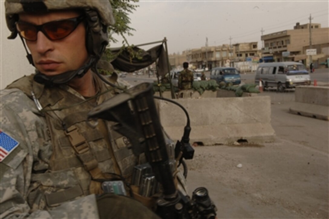 A U.S. Army soldier from Alpha Company, 4th Battalion, 23rd Infantry Regiment, 172nd Stryker Brigade Combat Team provides security during a humanitarian mission in the Bayaa district of Baghdad, Iraq, Oct. 19, 2006. 
