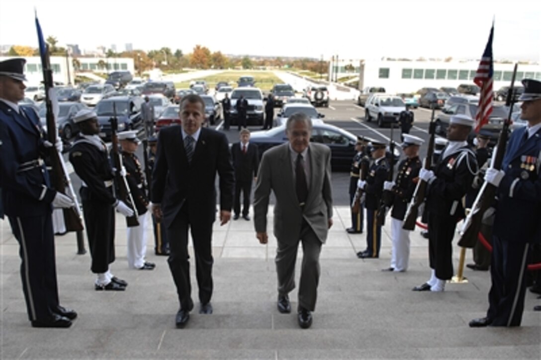 Secretary of Defense Donald H. Rumsfeld escorts the Estonian Minister of Defense Jurgen Ligi through a cordon of honor guards and into the Pentagon, Oct. 31, 2006. The two defense leaders met to discuss a range of international issues of mutual interest. 