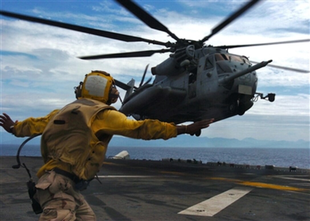 U.S. Navy Airman Sendy Jolicoeur directs a U.S. Marine Corps CH-53E Super Stallion helicopter to land aboard the USS Essex (LHD 2) as the ship operates in the Philippine Sea on Oct. 28, 2006.  The ship, its embarked Marines and Philippine armed forces are conducting bilateral training exercises Talon Vision and Amphibious Landing Exercise FY '07, designed to enhance interoperability and professional military relations.  