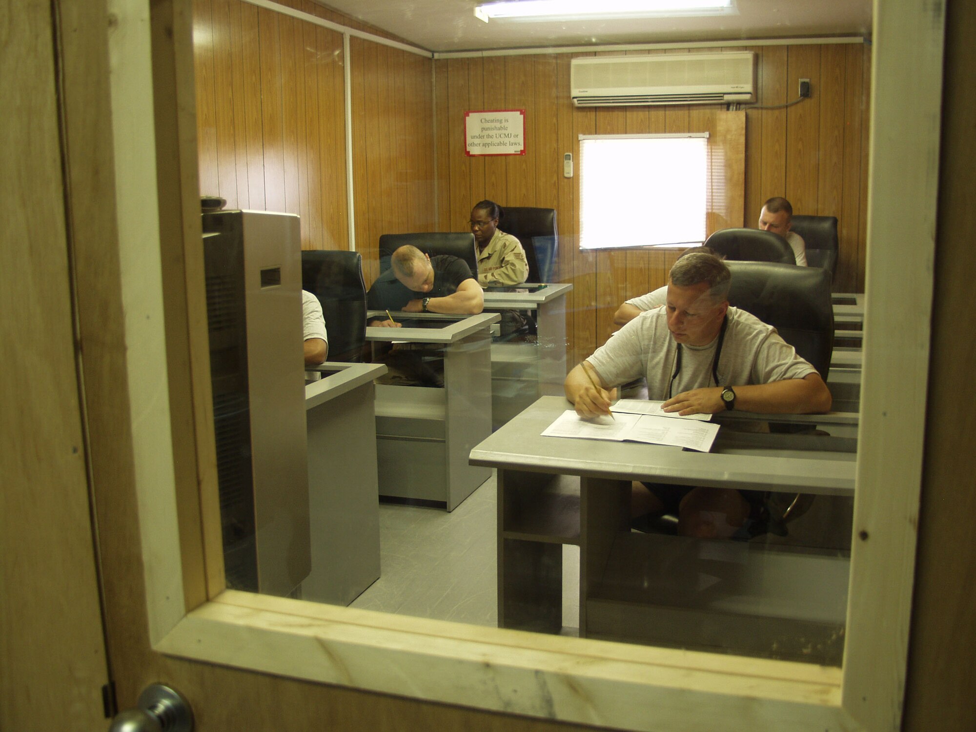 Air Force personnel test during an afternoon session at the Education Center at Balad Air Base, Iraq. The center offers three testing periods each day to help Airmen achieve academic advancement. (U.S. Air Force photo by 2nd Lt. Lisa Kostellic)