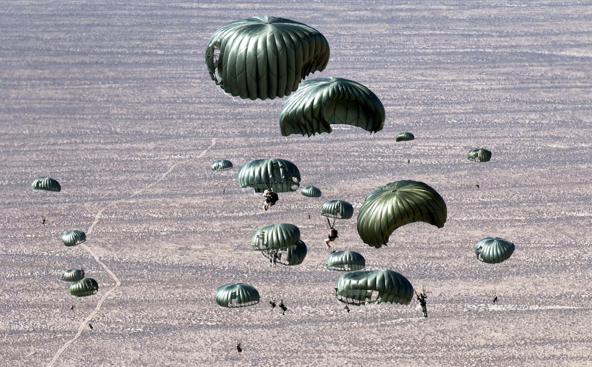 Pararescuemen from the 414th Combat Training Squadron and parachutists from the 820th Red Horse Squadron from Nellis Air Force Base, Nev., jump out of a C-130 Hercules Sept. 1 over the Nevada Test and Training Ranges in support of Red Flag Exercise 06-2. (U.S. Air Force photo/Master Sgt. Kevin Gruenwald)