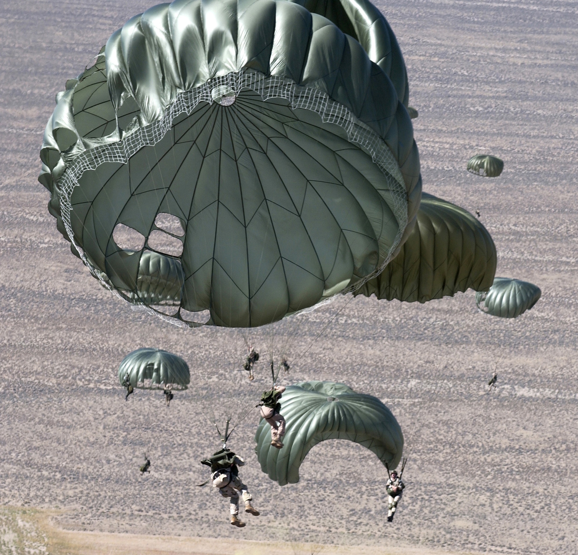 Pararescuemen from the 414th Combat Training Squadron and parachutists from the 820th Red Horse Squadron from Nellis Air Force Base, Nev., jump out of a C-130 Hercules Sept. 1 over the Nevada Test and Training Ranges in support of Red Flag Exercise 06-2. (U.S. Air Force photo/Master Sgt. Kevin Gruenwald)