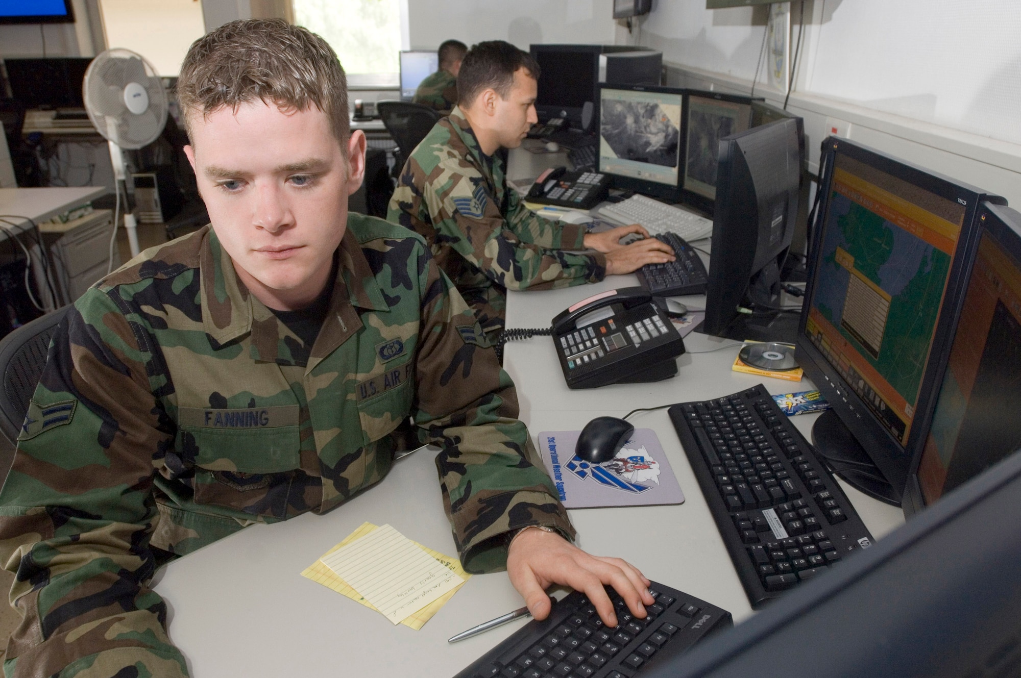 Airman 1st Class Andrew Fanning (left) and Staff Sgt. Heinz Disch forecast weather for the North Atlantic region from Sembach Air Base, Germany, Aug. 30. Sergeant Disch and Airman Fanning are weather forecasters with Sembach's 20th Operational Weather Squadron. (U.S. Air Force photo/Master Sgt. John Lasky) 