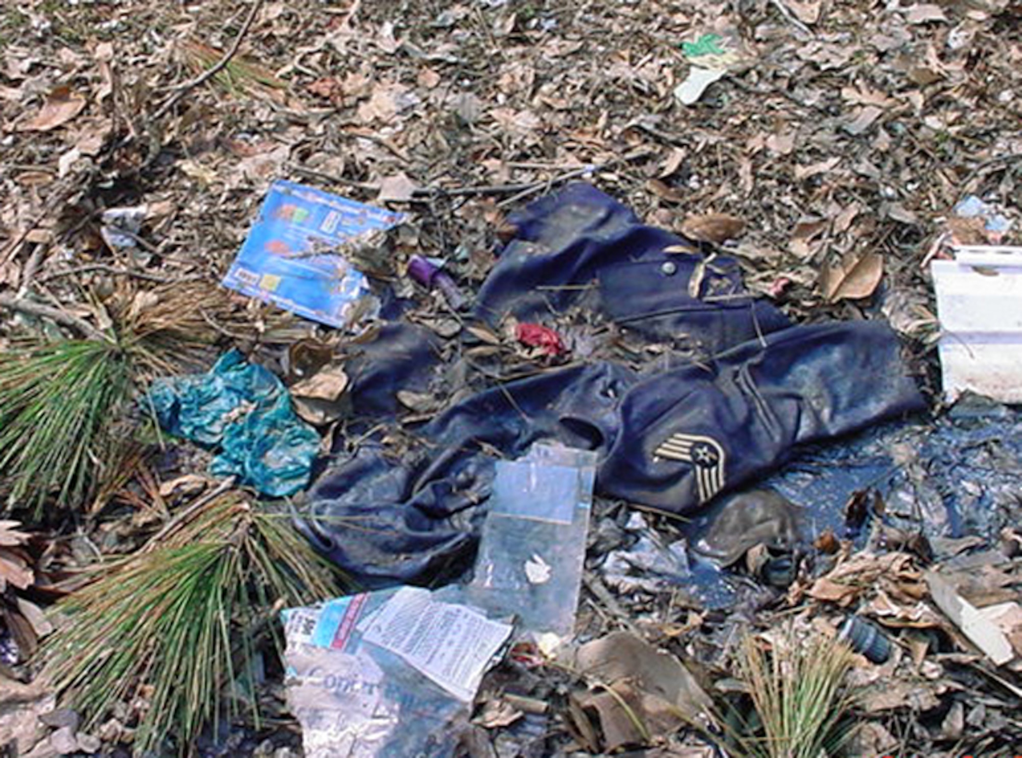 The enlisted uniforms of 1st Lt. Dawn Clifton lie in mud and trash in front of the Cliftons' home in Ocean Springs, Miss., after Hurricane Katrina. Lieutenant Clifton, who is prior enlisted, was stationed at Keesler Air Force Base, Miss., when the hurricane devastated the Gulf Coast in August 2005. (U.S. Air Force photo) 

