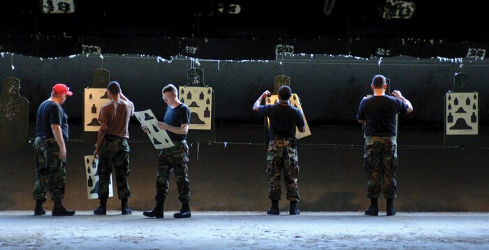 Airmen training with the M-16 rifle retrieve their targets at the combat arms range. The 437th Security Forces section provides weapons training to all base Airmen. (U.S. Navy photo by Petty Officer 2nd Class Leah Stiles) 