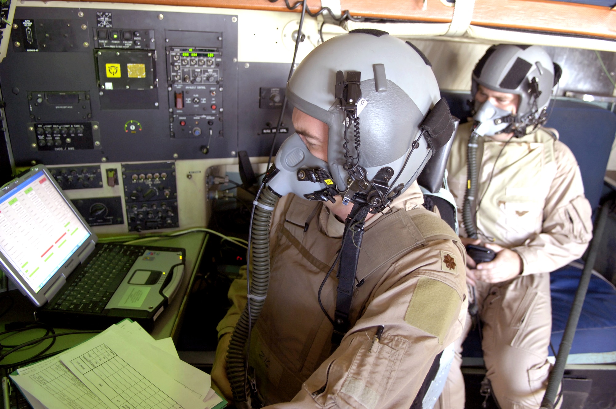 Maj. Russ Hedden and Maj. Daniel DeVoe look over the Joint Precision Air Drop System mission planner computer while on an airdrop mission over Afghanistan Aug. 25. Major Hedden is a navigator with the 774th Expeditionary Airlift Squadron. Major DeVoe is the command tactician at the Air Mobility Warfare Center. (U.S. Air Force photo/Senior Airman Brian Ferguson) 